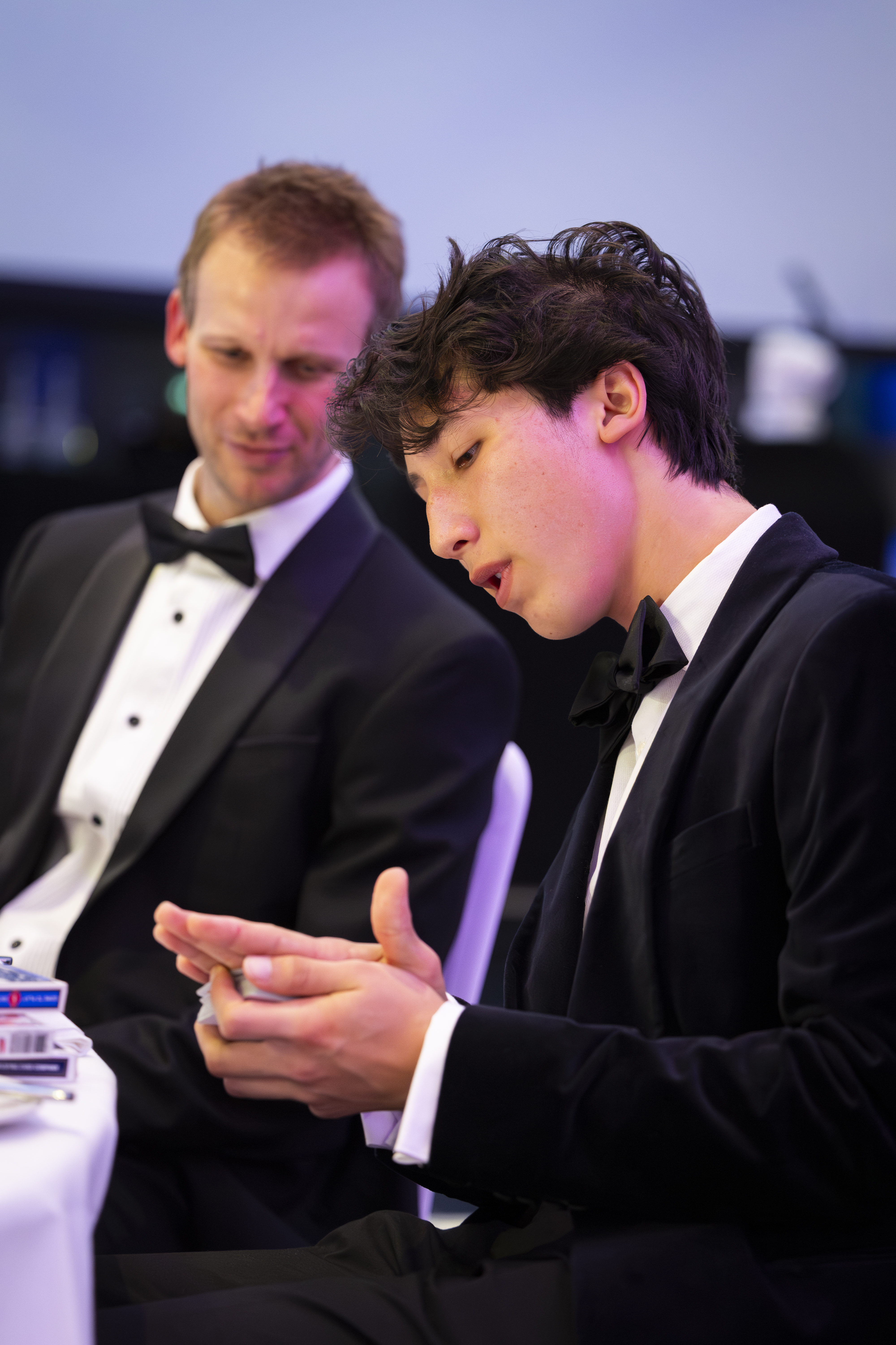 Noah performing close-up magic for guests